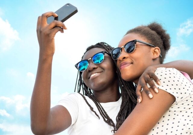 Two teenagers taking a selfie.