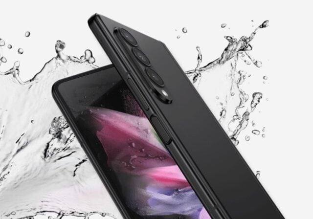 Two black phones being splashed by water.