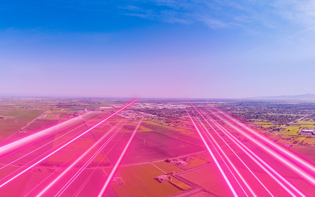 t-mobile network depicted with magenta light beams over a central valley rural community