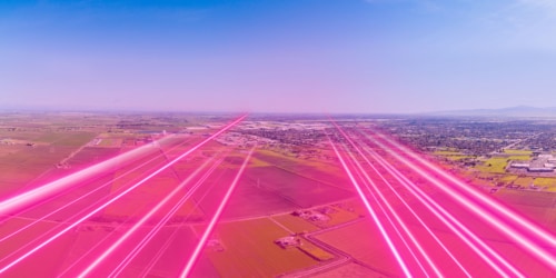 t-mobile network depicted with magenta light beams over a central valley rural community